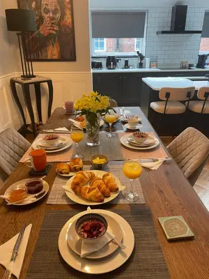 a wooden table with food and drinks on it at East Cliff in Preston