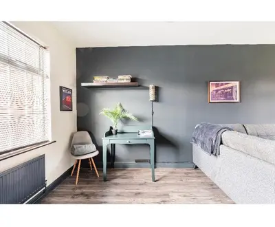 a room with a table and a bed and a window at T'house in wigan in Pemberton
