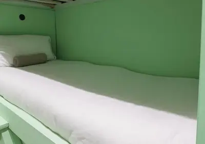 a large white bed in a small room at Pitchside Rooms Near Anfield in Liverpool