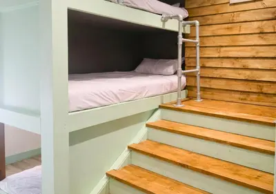 a bunk bed on the stairs of a tiny house at Pitchside Rooms Near Anfield in Liverpool