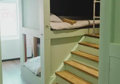 a room with stairs leading to a bunk bed at Pitchside Rooms Near Anfield in Liverpool