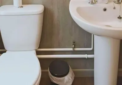 a bathroom with a white toilet and a sink at Pitchside Rooms Near Anfield in Liverpool