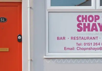 a sign in a window of a bar restaurant at Pitchside Rooms Near Anfield in Liverpool