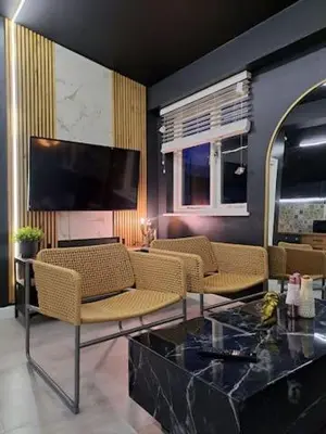 a living room with chairs and a flat screen tv at L2 APARTMENT- near CAVERN QUARTER in Liverpool