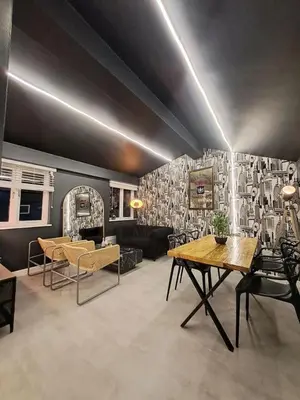 a living room with a table and some chairs at L2 APARTMENT- near CAVERN QUARTER in Liverpool