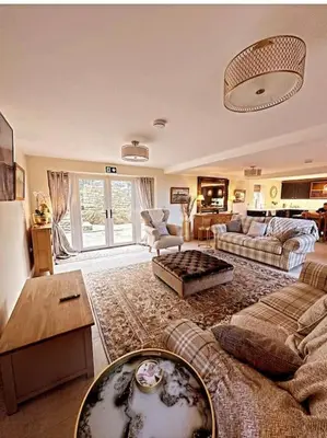 a living room with a couch and a table at Converted Barn with Hot Tub, The Hayloft. in Carnforth