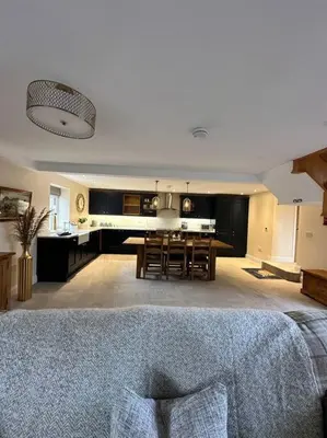 a living room with a kitchen and a dining room at Converted Barn with Hot Tub, The Hayloft. in Carnforth