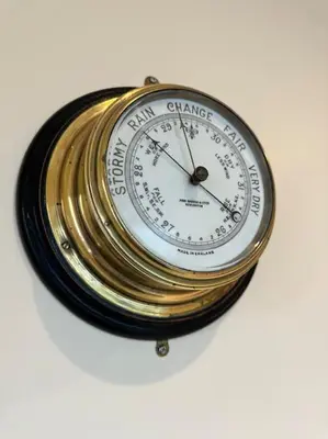 a gold and white clock on a white background at Converted Barn with Hot Tub, The Hayloft. in Carnforth
