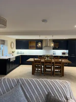 a kitchen with a table and a dining room at Converted Barn with Hot Tub, The Hayloft. in Carnforth