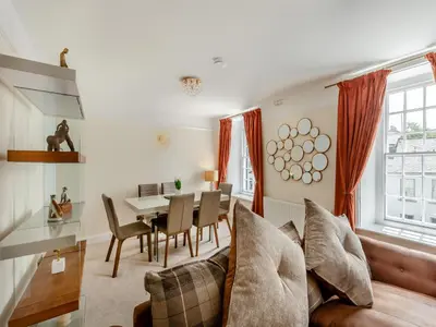 a living room with a couch and a table at Cartmel Place in Cartmel