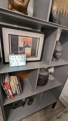 a book shelf with books and a picture on it at The road to Wigan Pier in Pemberton