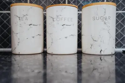 three white coffee cans sitting on a shelf at Anfield Abbey House in Liverpool