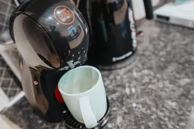 a coffee maker sitting on a counter with a cup at Anfield Abbey House in Liverpool