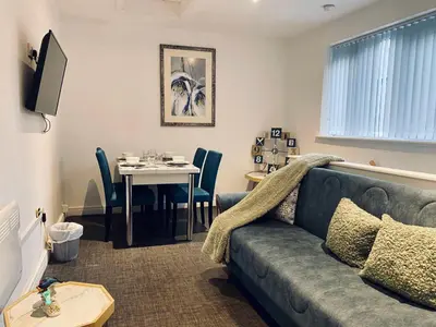 a living room with a couch and a table at Bethel Suite by Sasco Apartments in Blackpool