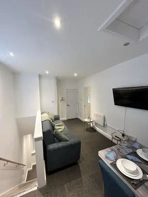 a living room with a couch and a flat screen tv at Bethel Suite by Sasco Apartments in Blackpool