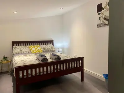 a bedroom with a bed with two towels on it at Bethel Suite by Sasco Apartments in Blackpool