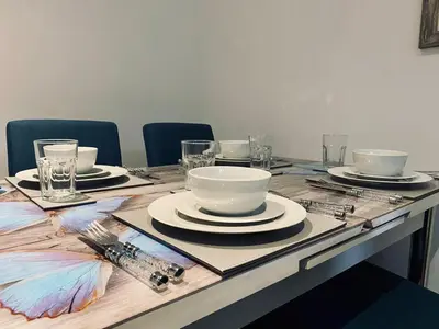 a table with plates and bowls on top of it at Bethel Suite by Sasco Apartments in Blackpool