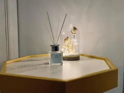 a bottle of perfume on a table with a vase at Bethel Suite by Sasco Apartments in Blackpool