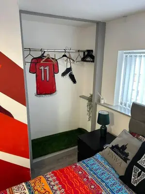 a bedroom with a red shirt hanging on a wall at 2-Bedroom Flat w/ En-Suites, Perfect for Groups in Liverpool