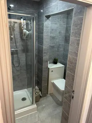 a bathroom with a shower and a toilet and a sink at 2-Bedroom Flat w/ En-Suites, Perfect for Groups in Liverpool