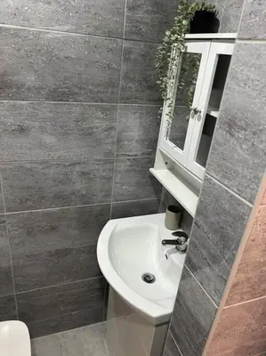 a bathroom with a white sink and a mirror at 2-Bedroom Flat w/ En-Suites, Perfect for Groups in Liverpool