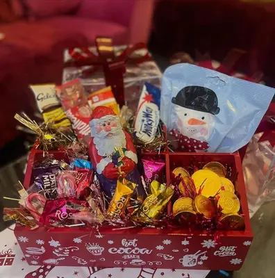 a box of christmas candy and santa clauses on a table at Winter Gardens Large Flat 1 in Blackpool