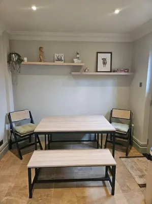 a room with two tables and chairs and shelves at Woodland Retreat in Lytham. in Lytham St Annes