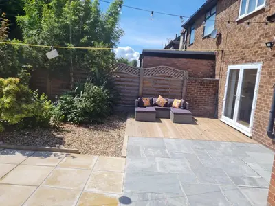 a patio with two couches on a wooden deck at 5Bed House Wirral near Liverpool Chester in Wirral