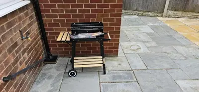 a cart sitting next to a brick wall at 5Bed House Wirral near Liverpool Chester in Wirral