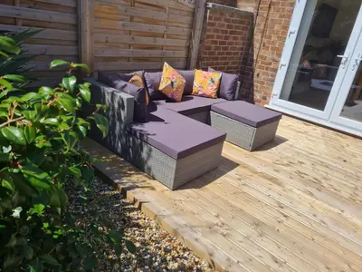 a patio with a couch and two pillows at 5Bed House Wirral near Liverpool Chester in Wirral