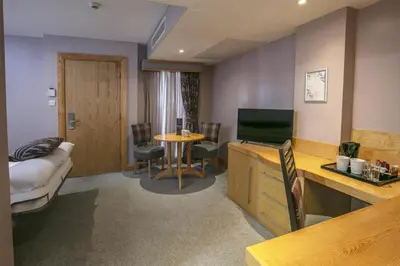 a hotel room with a bed and a television at Best Western Premier Suites Hotel & Spa Liverpool-Knowsley in Knowsley
