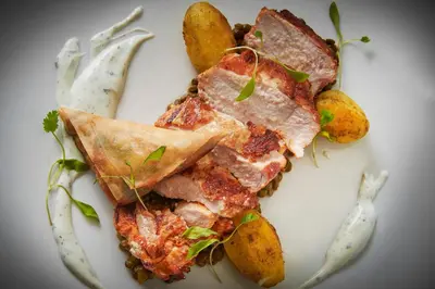 a plate of food with a slice of pizza and potatoes at Best Western Premier Suites Hotel & Spa Liverpool-Knowsley in Knowsley