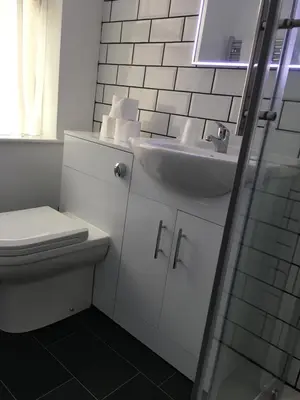 a bathroom with a toilet and a sink at Happy Return Hotel in Blackpool