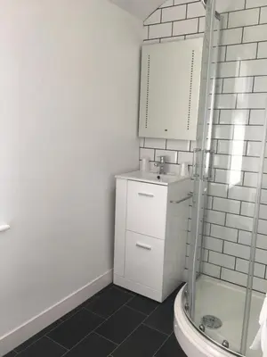 a bathroom with a sink and a mirror and a shower at Happy Return Hotel in Blackpool