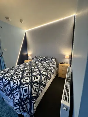 a bedroom with a bed with a black and white comforter at Winter Gardens Flat 4 Tower view family apartment in Blackpool
