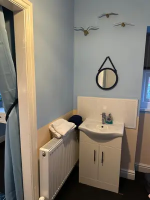 a bathroom with a sink and a mirror at Winter Gardens Flat 4 Tower view family apartment in Blackpool