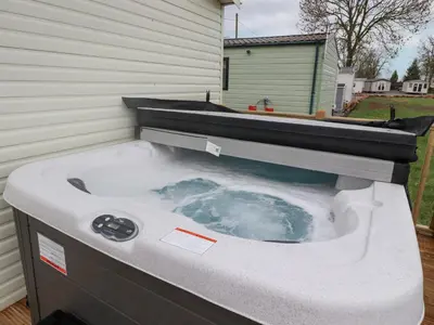 a hot tub sitting on the side of a house at Larenzo in Preston