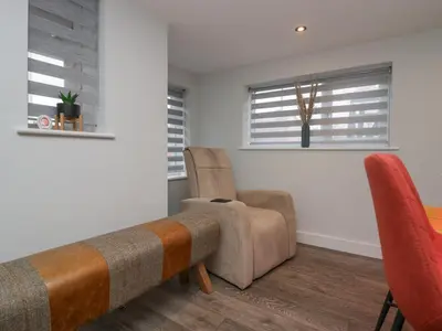 a living room with a table and chairs at Crag View Cottage in Barrow in Furness