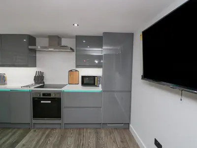 a kitchen with a microwave oven and a stove at Crag View Cottage in Barrow in Furness