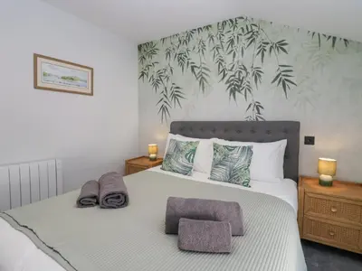 a bedroom with a bed with two towels on it at Crag View Cottage in Barrow in Furness