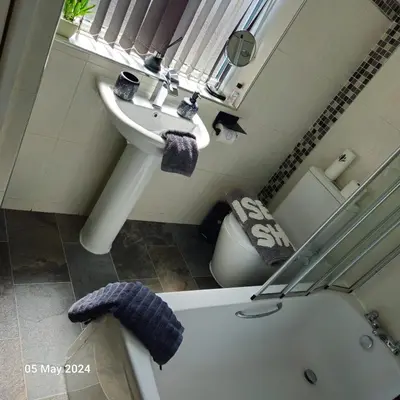 a bathroom with a sink and a tub next to a toilet at Aldwych house, For Holidays, Contractors & Relocation, Free Parking & Wi-Fi in Preston