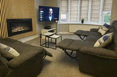 a living room with couches and a flat screen tv at Aldwych house, For Holidays, Contractors & Relocation, Free Parking & Wi-Fi in Preston