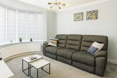 a living room with a couch and a table at Aldwych house, For Holidays, Contractors & Relocation, Free Parking & Wi-Fi in Preston