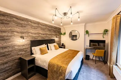 a bedroom with a large bed and a desk at Home at 42 Arkles Lane Anfield in Liverpool