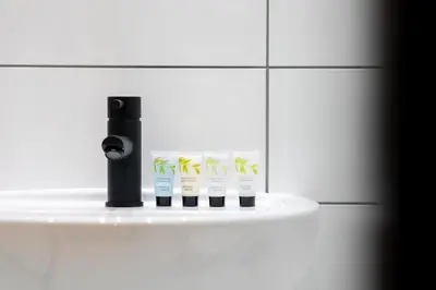 a group of four toothbrushes on a shelf in a bathroom at Home at 42 Arkles Lane Anfield in Liverpool