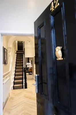 a view of a hallway with stairs in a house at Home at 42 Arkles Lane Anfield in Liverpool