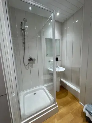 a bathroom with a shower and a sink at The Holmlea in Blackpool