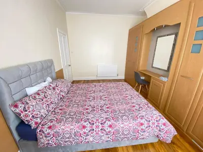 a bedroom with a bed and a desk and a window at Cozy Retreat Haven in Liverpool