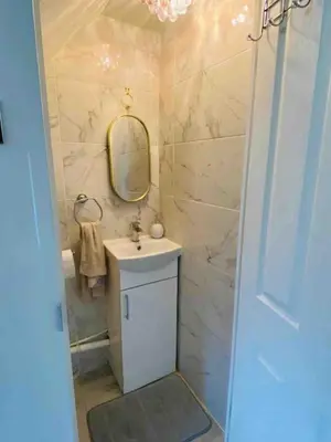 a bathroom with a sink and a mirror at Cozy Retreat Haven in Liverpool