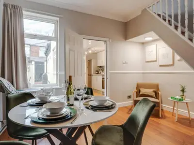 a dining room with a table and chairs at Ivy House, 3 Bed House, Parking - Pass the Keys in Liverpool